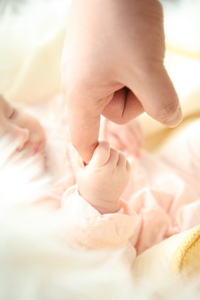 baby holding finger