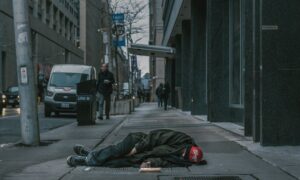 Man sleeping on sidewalk